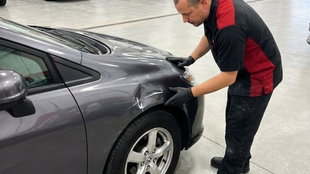 North Salt Lake Collision Repair tech inspecting damage